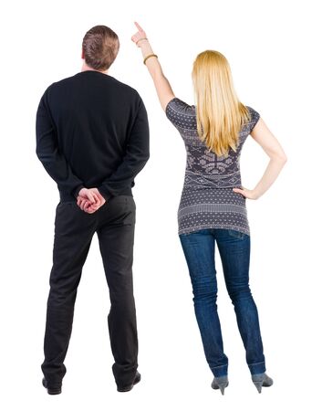 Back view of couple couple in sweater pointing. beautiful friendly girl and guy together. Rear view people collection. backside view of person. Isolated over white background.の写真素材