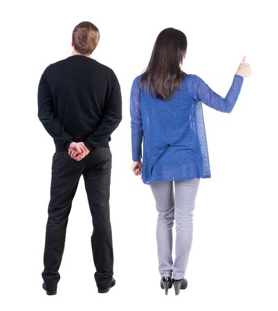 Back view of couple couple in sweater showing thumbs up. beautiful friendly girl and guy together. Rear view people collection. backside view of person. Isolated over white background.の写真素材