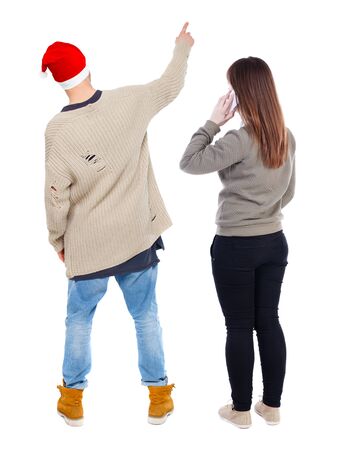 Back view of couple in sweater with mobile phone. beautiful friendly girl and guy together. Rear view people collection. backside view of person. Isolated over white background.の写真素材