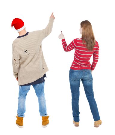 Back view of couple couple in sweater showing thumbs up. beautiful friendly girl and guy together. Rear view people collection. backside view of person. Isolated over white background.の写真素材