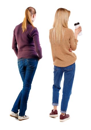Back view of two woman in sweater. beautiful friendly girl and guy together. Rear view people collection. backside view of person. Isolated over white background.の写真素材