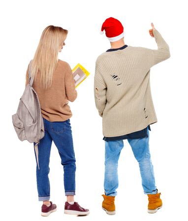 Back view of couple couple in sweater showing thumbs up. beautiful friendly girl and guy together. Rear view people collection. backside view of person. Isolated over white background.の写真素材