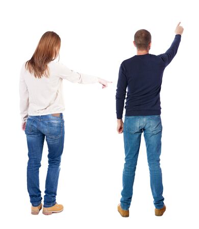Back view of couple couple in sweater pointing. beautiful friendly girl and guy together. Rear view people collection. backside view of person. Isolated over white background.の写真素材