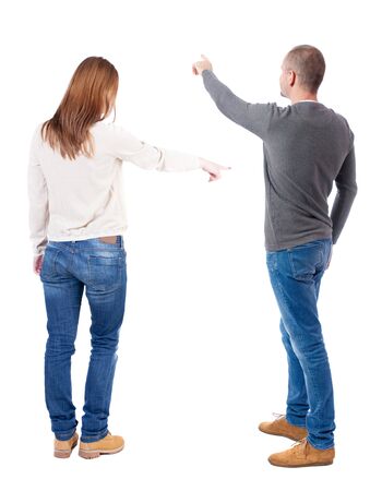 Back view of couple couple in sweater pointing. beautiful friendly girl and guy together. Rear view people collection. backside view of person. Isolated over white background.の写真素材
