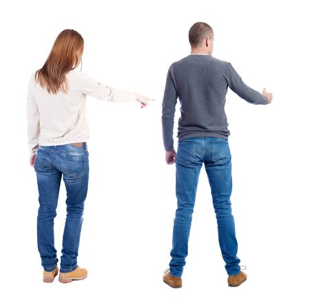 Back view of couple couple in sweater pointing. beautiful friendly girl and guy together. Rear view people collection. backside view of person. Isolated over white background.の写真素材