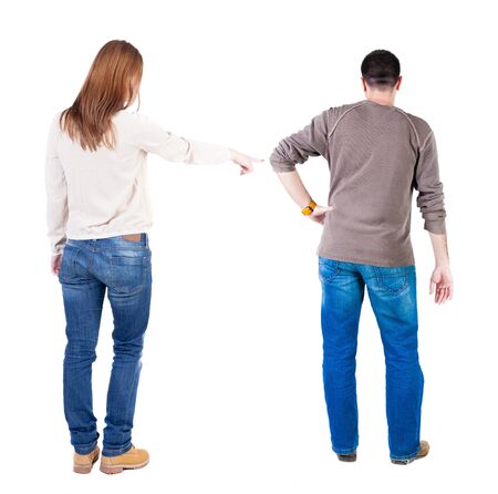 Back view of couple couple in sweater pointing. beautiful friendly girl and guy together. Rear view people collection. backside view of person. Isolated over white background.の写真素材