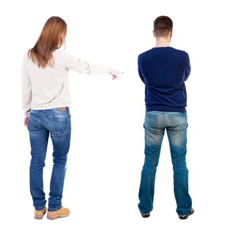 Back view of couple couple in sweater pointing. beautiful friendly girl and guy together. Rear view people collection. backside view of person. Isolated over white background.の写真素材