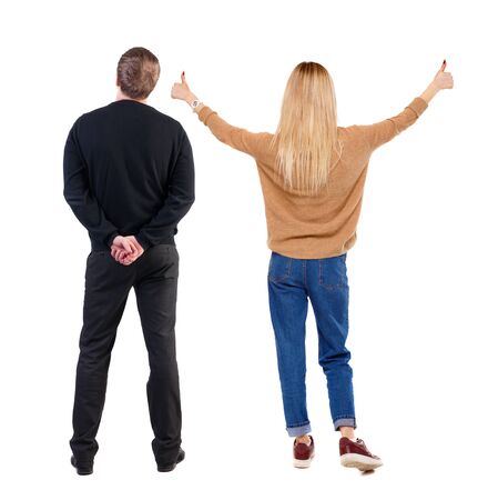 Back view of couple couple in sweater showing thumbs up. beautiful friendly girl and guy together. Rear view people collection. backside view of person. Isolated over white background.の写真素材