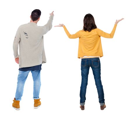 Back view of couple couple in sweater pointing. beautiful friendly girl and guy together. Rear view people collection. backside view of person. Isolated over white background.の写真素材