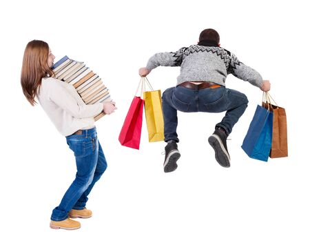 back view of couple with shopping bags. backside view of person. Rear view people collection. Isolated over white background.の写真素材
