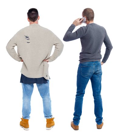 Back view of two man in sweater with mobile phone. Rear view people collection. backside view of person. Isolated over white background.の写真素材