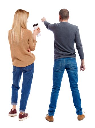 Back view of couple couple in sweater pointing. Rear view people collection. backside view of person. Isolated over white background.の写真素材