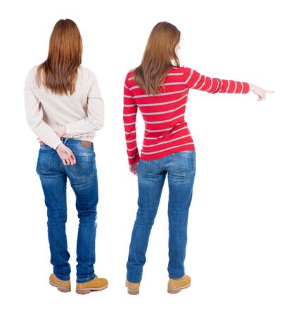 Back view of two pointing girl in sweater. Rear view people collection. backside view of person. beautiful woman showing gesture. Rear view. Isolated over white background.の写真素材