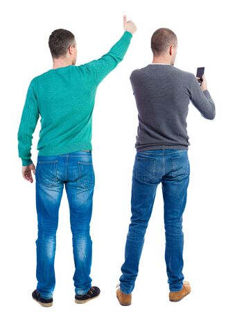 Back view of two man in sweater with mobile phone. Rear view people collection. backside view of person. Isolated over white background.の写真素材