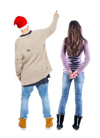 Back view of couple couple in sweater pointing. Rear view people collection. backside view of person. Isolated over white background.の写真素材