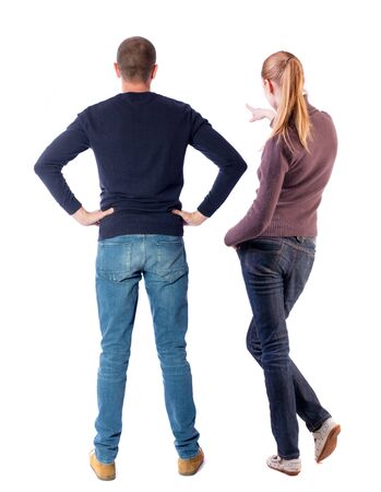 Back view of couple couple in sweater pointing. Rear view people collection. backside view of person. Isolated over white background.の写真素材