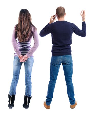 Back view of couple in sweater with mobile phone. Rear view people collection. backside view of person. Isolated over white background.の写真素材