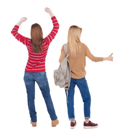 Back view of two woman in sweater showing thumb up. Rear view people collection. backside view of person. Rear view. Isolated over white background.の写真素材