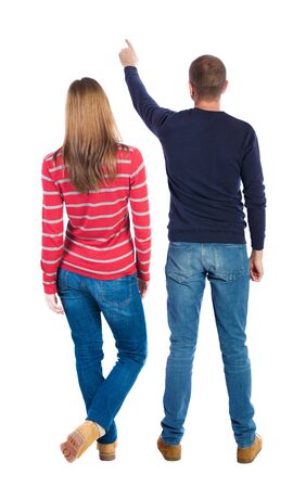 Back view of couple couple in sweater pointing. Rear view people collection. backside view of person. Isolated over white background.の写真素材