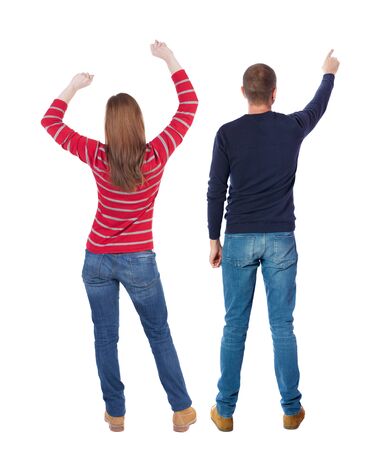 Back view of couple couple in sweater pointing. Rear view people collection. backside view of person. Isolated over white background.の写真素材