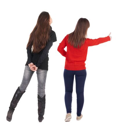 Back view of two woman in sweater showing thumb up. Rear view people collection. backside view of person. Rear view. Isolated over white background.の写真素材