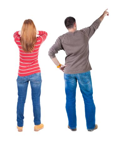 Back view of couple couple in sweater pointing. Rear view people collection. backside view of person. Isolated over white background.の写真素材