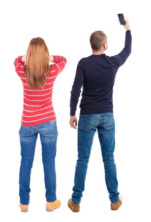 Back view of couple in sweater with mobile phone. Rear view people collection. backside view of person. Isolated over white background.の写真素材