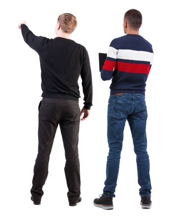 Back view of two man in sweater pointing. Rear view people collection. backside view of person. Isolated over white background. Guys stare aheadの写真素材