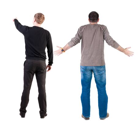 Back view of two man in sweater pointing. Rear view people collection. backside view of person. Isolated over white background. Guys stare aheadの写真素材