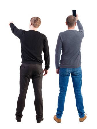 Back view of two man in sweater with mobile phone. Rear view people collection. backside view of person. Isolated over white background.の写真素材