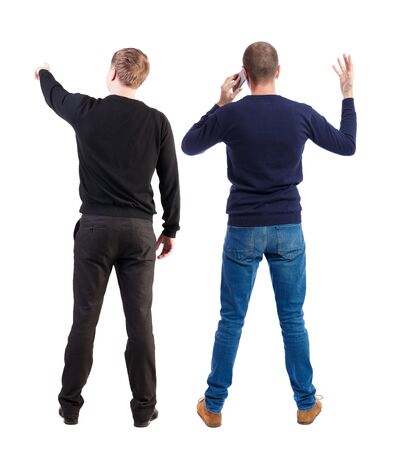 Back view of two man in sweater with mobile phone. Rear view people collection. backside view of person. Isolated over white background.の写真素材