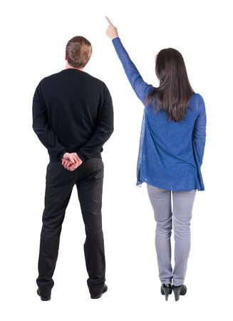 Back view of couple couple in sweater pointing. Rear view people collection. backside view of person. Isolated over white background.の写真素材