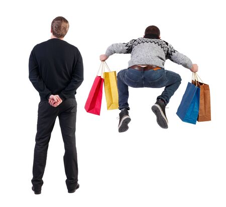 back view of two man with shopping bags. backside view of person. Rear view people collection. Isolated over white background. Two man in a store.の写真素材