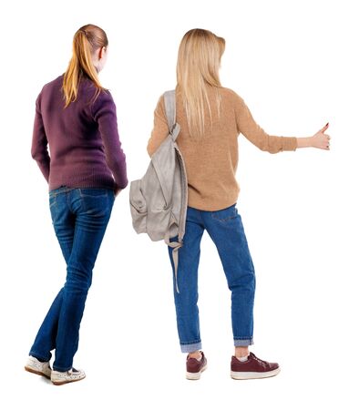 Back view of two woman in sweater showing thumb up. Rear view people collection. backside view of person. Rear view. Isolated over white background.の写真素材