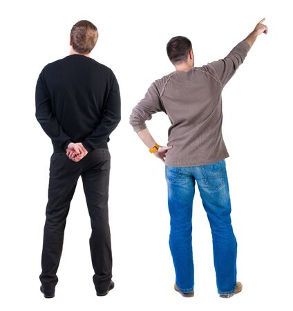 Back view of two man in sweater pointing. Rear view people collection. backside view of person. Isolated over white background. Guys stare aheadの写真素材