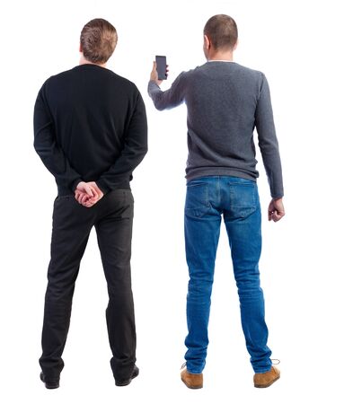 Back view of two man in sweater with mobile phone. Rear view people collection. backside view of person. Isolated over white background.の写真素材