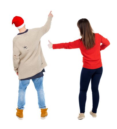 Back view of couple couple in sweater pointing. Rear view people collection. backside view of person. Isolated over white background.の写真素材