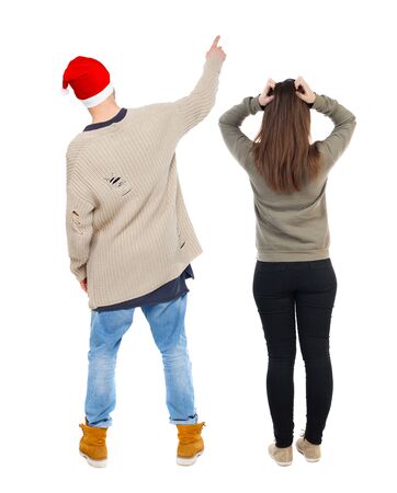 Back view of couple couple in sweater pointing. Rear view people collection. backside view of person. Isolated over white background.の写真素材