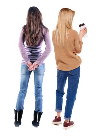 Back view of two woman in sweater. Rear view people collection. backside view of person. Isolated over white background. Girls are looking forwardの写真素材