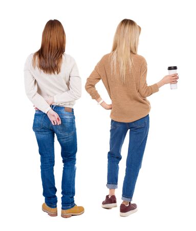 Back view of two woman in sweater. Rear view people collection. backside view of person. Isolated over white background. Girls are looking forwardの写真素材
