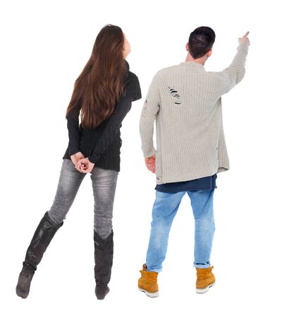 Back view of couple couple in sweater pointing. Rear view people collection. backside view of person. Isolated over white background.の写真素材