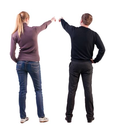 Back view of couple in sweater pointing. Rear view people collection. backside view of person. Isolated over white background.の写真素材