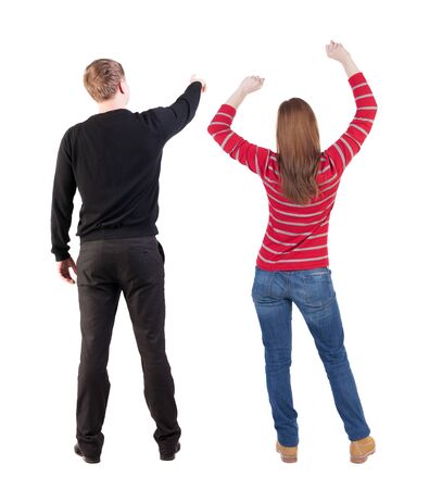 Back view of couple in sweater pointing. Rear view people collection. backside view of person. Isolated over white background.の写真素材