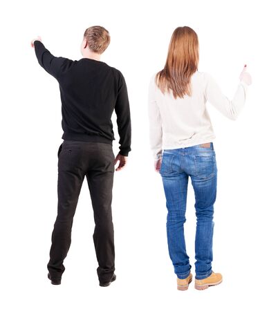 Back view of couple in sweater pointing. Rear view people collection. backside view of person. Isolated over white background.の写真素材