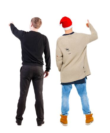 Back view of two man in sweater pointing. Rear view people collection. backside view of person. Isolated over white background. Guys stare aheadの写真素材