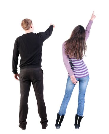 Back view of couple in sweater pointing. Rear view people collection. backside view of person. Isolated over white background.の写真素材