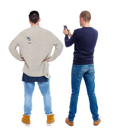 Back view of two man in sweater with mobile phone. Rear view people collection. backside view of person. Isolated over white background.の写真素材