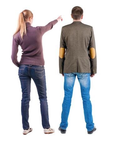 Back view of couple in sweater pointing. Rear view people collection. backside view of person. Isolated over white background.の写真素材