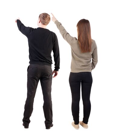Back view of couple in sweater pointing. Rear view people collection. backside view of person. Isolated over white background.の写真素材