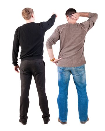 Back view of two man in sweater pointing. Rear view people collection. backside view of person. Isolated over white background. Guys stare aheadの写真素材